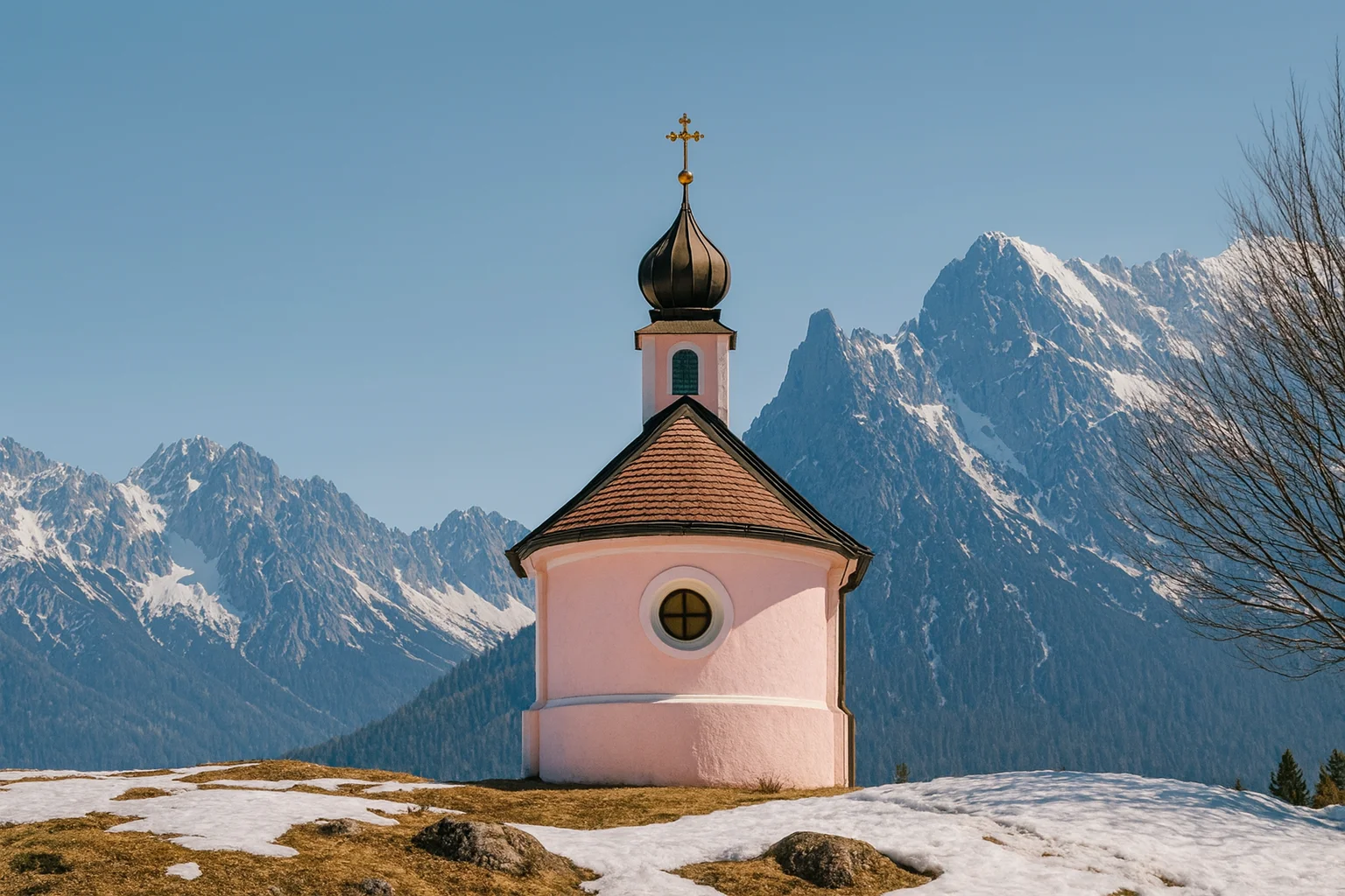 A pink chapel on a hill surrounded by snowy mountains.